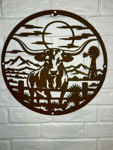 Laser-cut western metal wall art featuring a longhorn and ranch landscape